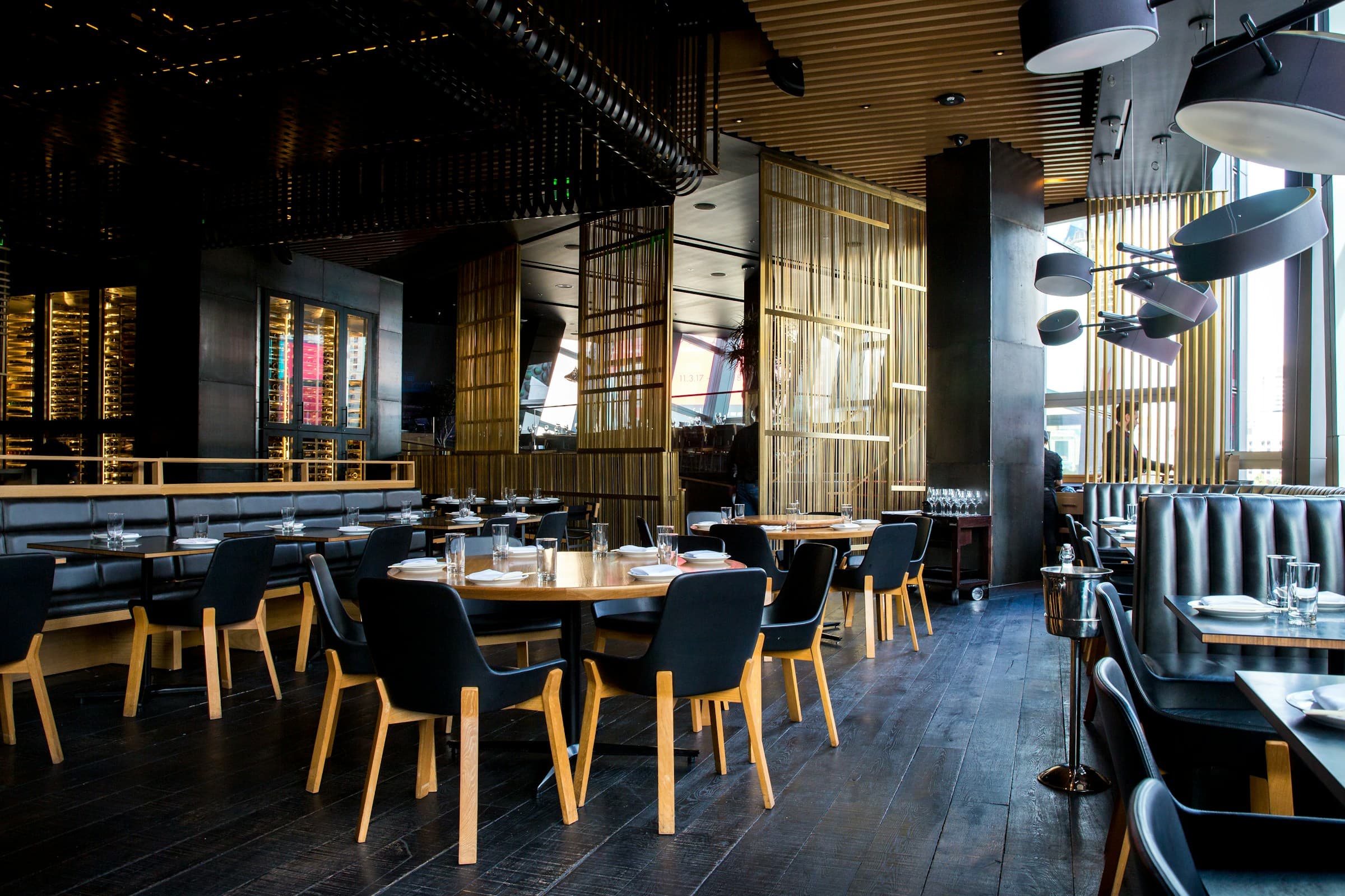 A restaurant interior with set tables and warm ambient light